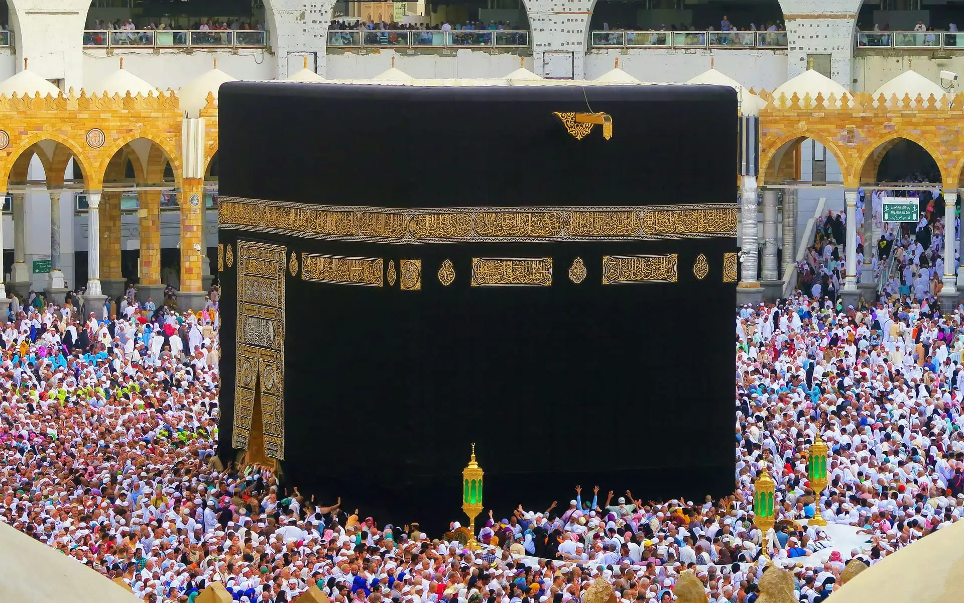 Pilgrims in ihram gathered around the Kaaba beneath the gold embroidered kiswah in Masjid al-Haram
